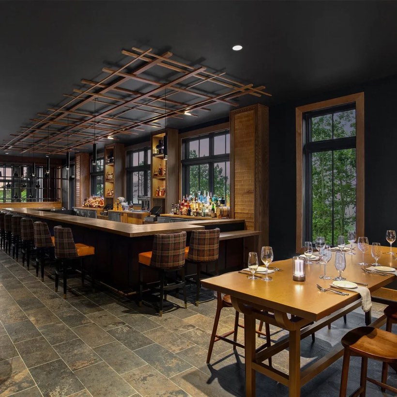 A candlelit fine-dining room set for dinner.